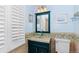 Bathroom with turquoise walls features a decorative mirror, glass sink and a patterned tile backsplash at 35 S Albion St, Denver, CO 80246