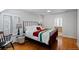 Well-lit bedroom with warm hardwood floors, black iron bedframe, and a decorative window at 35 S Albion St, Denver, CO 80246