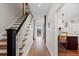 Bright entryway featuring hardwood floors, stairs with white risers, and a view into the open kitchen at 35 S Albion St, Denver, CO 80246