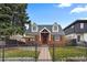 Charming brick home featuring a landscaped front yard with black iron fence, seating area, and inviting walkway at 35 S Albion St, Denver, CO 80246