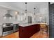 Modern kitchen with stainless steel appliances, island with seating, and granite countertops at 35 S Albion St, Denver, CO 80246