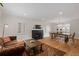 Open-concept living and dining space with hardwood floors, shutters, modern lighting and a dark fireplace at 35 S Albion St, Denver, CO 80246