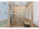 Tiled shower with a shower head, shower controls, glass door and corner seat at 35 S Albion St, Denver, CO 80246