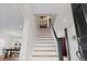 Staircase featuring wood steps, white risers and a decorative window at the top of the stairs at 35 S Albion St, Denver, CO 80246