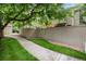 Backyard walkway and fence create a private, secluded retreat with greenery and mature trees at 7925 W Layton Ave # 605, Littleton, CO 80123