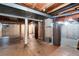 Unfinished basement with exposed ductwork, support beams, and water heater. Includes unfinished storage and potential utility area at 7925 W Layton Ave # 605, Littleton, CO 80123