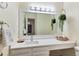 Bright bathroom vanity features updated sink, quartz countertop and modern lighting at 7925 W Layton Ave # 605, Littleton, CO 80123