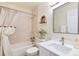 Cozy bathroom features a tub with shower, a vanity with sink, and neutral tones at 7925 W Layton Ave # 605, Littleton, CO 80123
