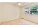 Carpeted bedroom with neutral tones, window with trees, and ample natural light at 7925 W Layton Ave # 605, Littleton, CO 80123