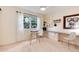 Carpeted bedroom features a built-in desk with bright lighting, and a large window overlooking trees at 7925 W Layton Ave # 605, Littleton, CO 80123