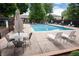 Community pool with lounge chairs and tables perfect for relaxation at 7925 W Layton Ave # 605, Littleton, CO 80123