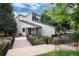 Exterior home view of the property showcasing bridge, landscaping, pond and architectural details at 7925 W Layton Ave # 605, Littleton, CO 80123