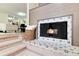 Cozy living room features a beautiful fireplace with a decorative tile surround and a basket for storage at 7925 W Layton Ave # 605, Littleton, CO 80123