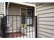 Exterior view of front entrance, enclosed by a black metal fence, and showcasing decorative flowerpots at 7925 W Layton Ave # 605, Littleton, CO 80123