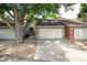 Inviting townhouse featuring an attached two-car garage, well-maintained landscaping, and a charming entryway at 7925 W Layton Ave # 605, Littleton, CO 80123