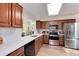 Well-lit kitchen with stainless steel appliances, ample counter space, and stylish backsplash at 7925 W Layton Ave # 605, Littleton, CO 80123