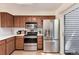 Modern kitchen with stainless steel appliances, updated cabinetry, and a view to the exterior at 7925 W Layton Ave # 605, Littleton, CO 80123