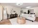 Bright living room featuring hardwood floors, contemporary furnishings, and an open layout to the dining area at 7925 W Layton Ave # 605, Littleton, CO 80123