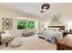 Light filled primary bedroom with vaulted ceiling, a window view of trees and comfortable furnishings at 7925 W Layton Ave # 605, Littleton, CO 80123