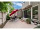 Outdoor patio with a small table with umbrella, furniture, and potted plants just outside sliding glass doors at 7925 W Layton Ave # 605, Littleton, CO 80123
