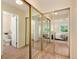 Walk-in closet features mirrors, storage, and access to the attached primary bathroom and primary bedroom at 7925 W Layton Ave # 605, Littleton, CO 80123