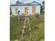 View of a boarded-up home with a weathered walkway, a mailbox, and a chain-link fence at 3701 W 9Th Ave, Denver, CO 80204
