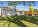 Large backyard with mature trees, lawn, and patio at 8242 E Briarwood Pl, Centennial, CO 80112
