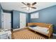 Comfortable bedroom with shuttered windows, ceiling fan, wood floors, and adjacent doors at 8242 E Briarwood Pl, Centennial, CO 80112