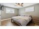 Cozy bedroom with wood floors, light gray walls, and shutters at 8242 E Briarwood Pl, Centennial, CO 80112
