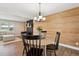 Charming dining room with wood-paneled wall feature adjacent to the living room and fireplace at 8242 E Briarwood Pl, Centennial, CO 80112