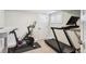 Home exercise room with a Peloton bike and treadmill at 8242 E Briarwood Pl, Centennial, CO 80112