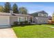 Charming home with well-manicured lawn, updated exterior, and welcoming front porch at 8242 E Briarwood Pl, Centennial, CO 80112