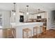 Eat-in kitchen with island, white cabinets, pendant lights, and stainless steel appliances, offers a stylish design at 8242 E Briarwood Pl, Centennial, CO 80112