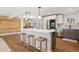 Spacious kitchen features a central island, white cabinets, stainless appliances and wood floors throughout at 8242 E Briarwood Pl, Centennial, CO 80112