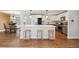 Modern kitchen boasts a large island with seating, stainless steel appliances, and stylish pendant lighting at 8242 E Briarwood Pl, Centennial, CO 80112