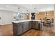 Open-concept kitchen features a large island with seating that flows into the dining room and living room at 8242 E Briarwood Pl, Centennial, CO 80112
