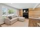 Bright living room features a large window, modern decor, and a fireplace to create a cozy ambiance at 8242 E Briarwood Pl, Centennial, CO 80112