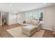 Comfortable living room featuring a large window with bright natural light and plush seating at 8242 E Briarwood Pl, Centennial, CO 80112