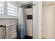 Modern black and white tiled shower with black shower head and built in niche at 8242 E Briarwood Pl, Centennial, CO 80112