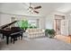 Inviting living room with neutral tones, a grand piano, plush seating, and a large window at 8220 S Brentwood St, Littleton, CO 80128