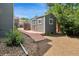 Backyard view of shed with a ramp and a gravel area in a well-maintained yard at 8220 S Brentwood St, Littleton, CO 80128