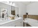 Bright bathroom features a double sink vanity, soaking tub with tile surround, and a separate shower at 9471 Ashbury Cir # 202, Parker, CO 80134