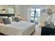 Serene bedroom with soft natural light, a comfortable bed, and a private balcony overlooking the surrounding neighborhood at 9471 Ashbury Cir # 202, Parker, CO 80134