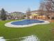 A community pool with a safety cover sits among the community homes, creating a nice amenity at 9471 Ashbury Cir # 202, Parker, CO 80134