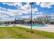 A community pool sits ready to be enjoyed during the summer, with lounge chairs and a water slide at 9471 Ashbury Cir # 202, Parker, CO 80134