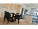 Open concept dining area adjacent to a kitchen featuring a modern table and gray chairs for stylish entertaining at 9471 Ashbury Cir # 202, Parker, CO 80134