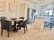 Open concept dining area adjacent to a kitchen featuring a modern table and gray chairs for stylish entertaining at 9471 Ashbury Cir # 202, Parker, CO 80134