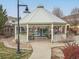 Community gazebo offering shade and seating, surrounded by greenery and a walking path at 9471 Ashbury Cir # 202, Parker, CO 80134