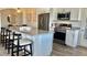 Modern kitchen featuring stainless steel appliances, white cabinetry, granite countertops and breakfast bar seating at 9471 Ashbury Cir # 202, Parker, CO 80134