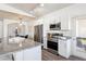 Contemporary kitchen boasts stainless steel appliances, granite countertops, and open access to dining area at 9471 Ashbury Cir # 202, Parker, CO 80134